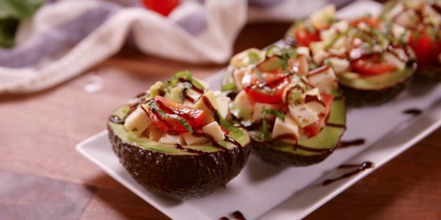 Salad with tomatoes and mozzarella in avocado boats