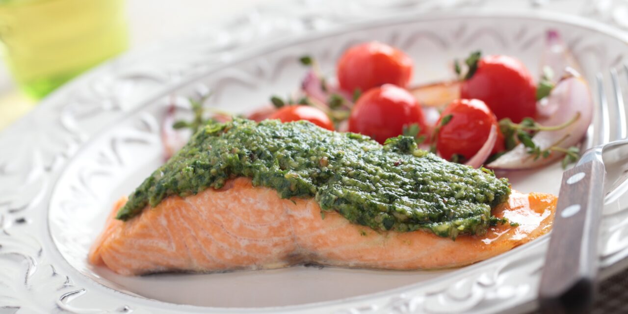 Salmon with pesto and tomatoes in foil
